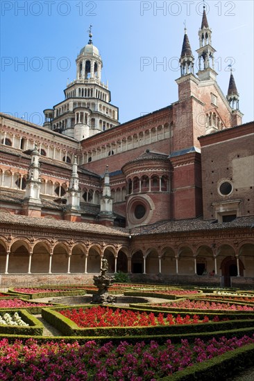 Inner courtyard decorated with planted flowers behind cloister