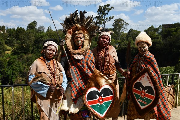 Kikuyu dancer with face paint poses for photographers at Nyahururu Falls