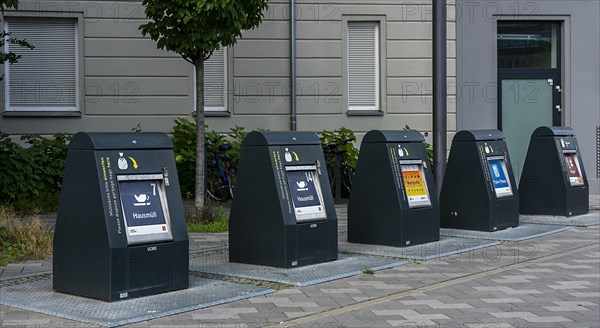 Modern household waste containers in front of new buildings in Europacity