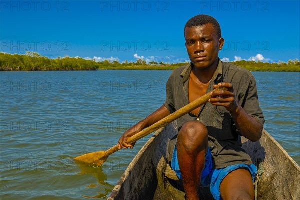 Man paddling through the mangroves of the Island Ile Sainte-Marie although Nosy Boraha