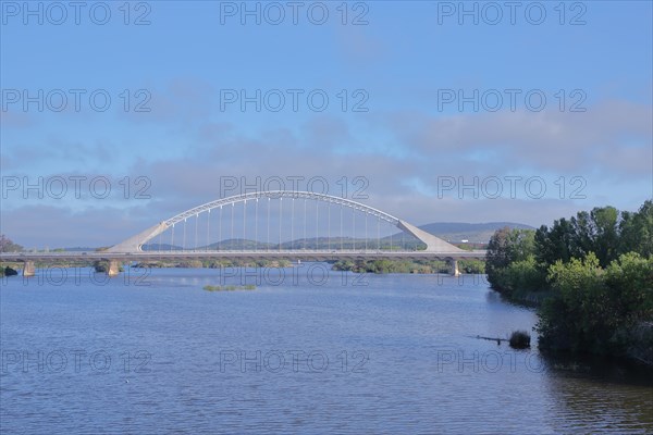 Modern arch bridge Puente Lusitanos built in 1992 over the river Rio Guadiana