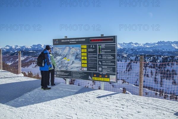 Senior holidaymaker couple looking at panorama map