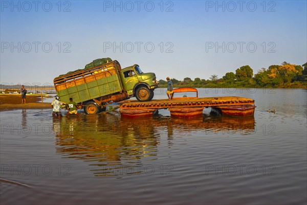 Truck crossing on a improvised ferry the Manambolo river