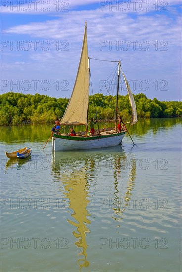 Little sailing boat shipping on a side arm