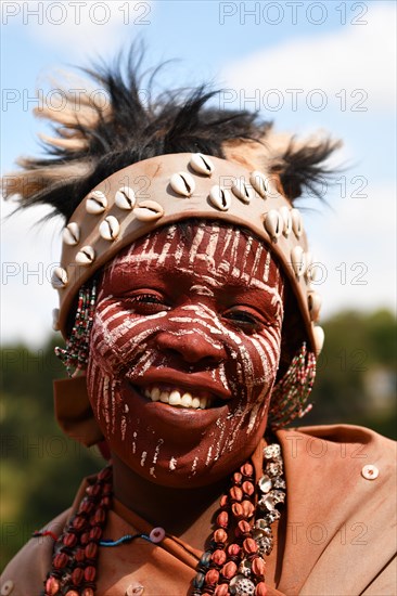 Kikuyu woman with face paint poses for photographers at Nyahururu Falls