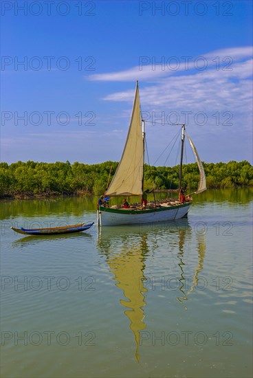 Little sailing boat shipping on a side arm