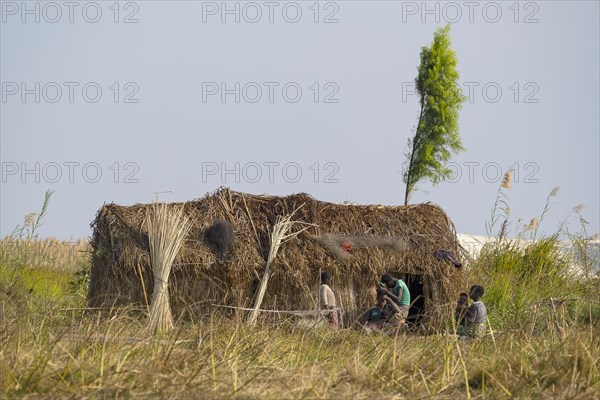 Local people with reed house