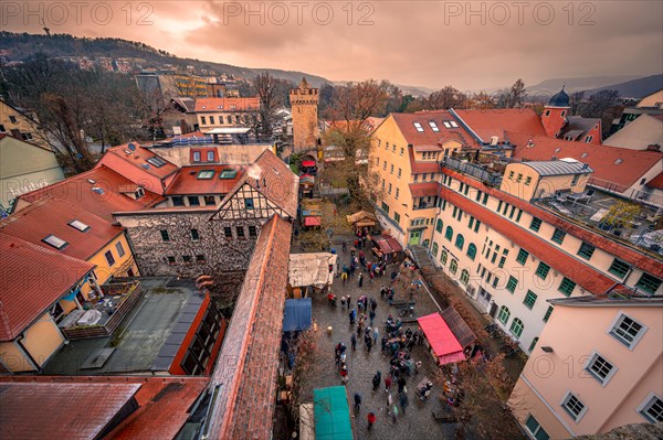 View of the medieval Christmas market in the Faulloch directly on the city wall with a view of the Powder Tower at sunset