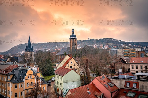 View of the Friedenskirche in the centre of Jena with the Landgrave in the background at sunset