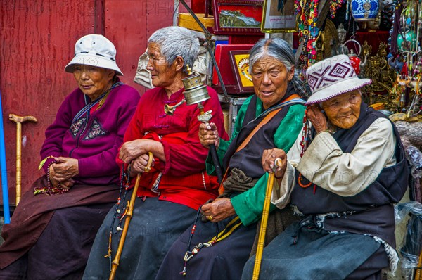 Old tibetan pigrims on the Barkhor devotional circumambulation for pilgrims and locals