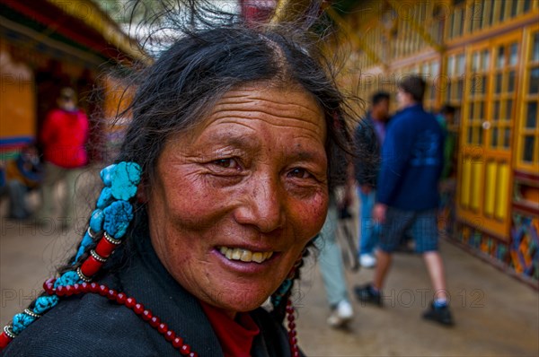 Old tibetan pilgrim in the Drepung temple