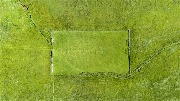 Aerial view of a football field in the Allgaeu region with a stream as a sideline