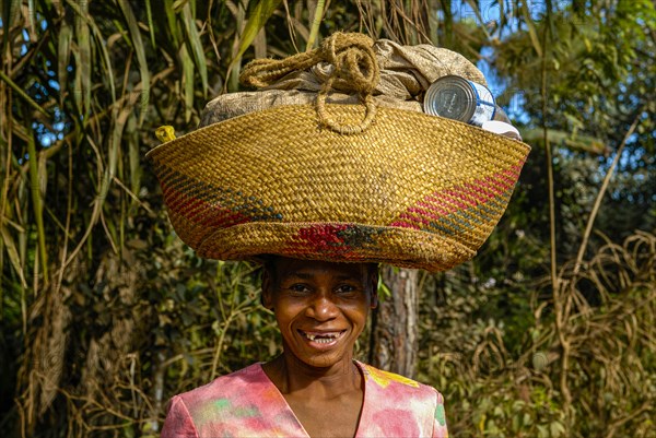 Woman carrying a bag on her head