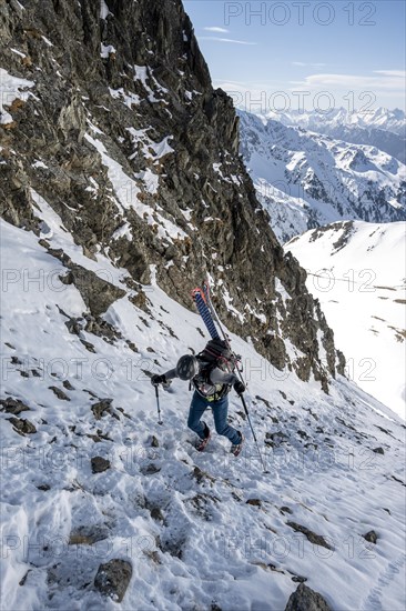 Ski tourers on the ascent in a saddle