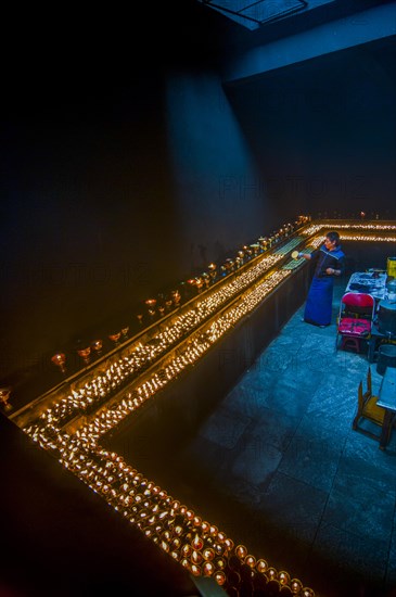 Dark room with many candles in the Ramoche temple