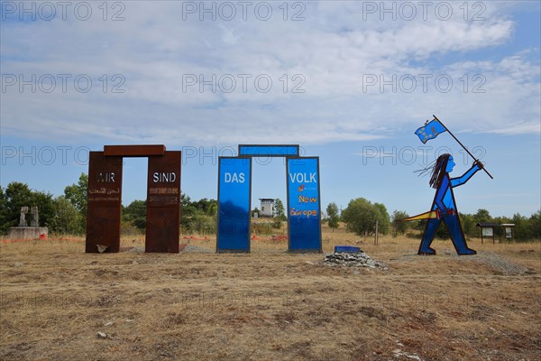 Sculpture with inscription We are the people and blue Indian