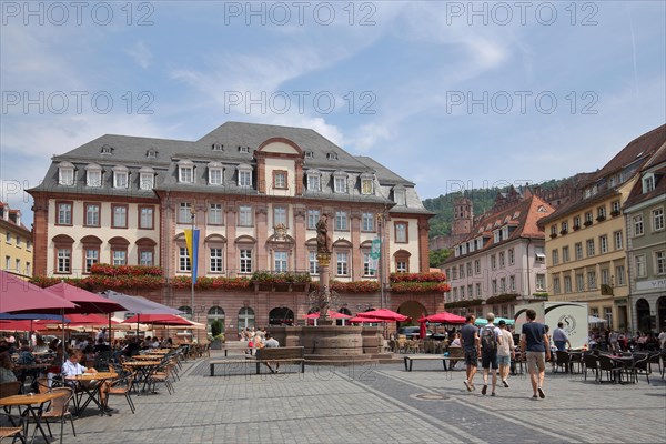 Town hall at the market place with street pub and people in Heidelberg