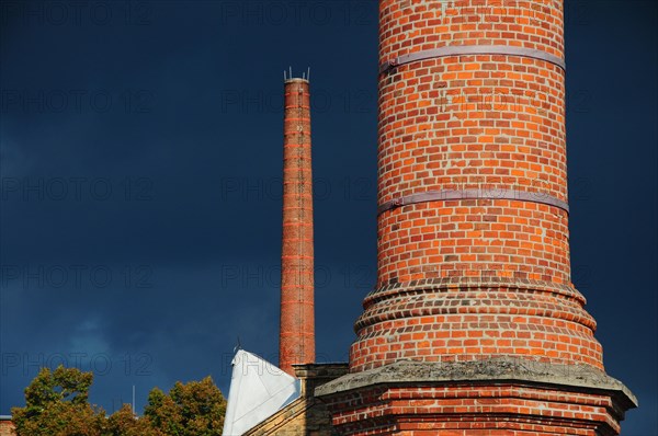 Factory chimney in front of storm clouds