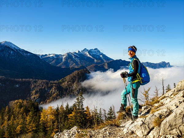 Mountaineer above forest line and clouds enjoying the view