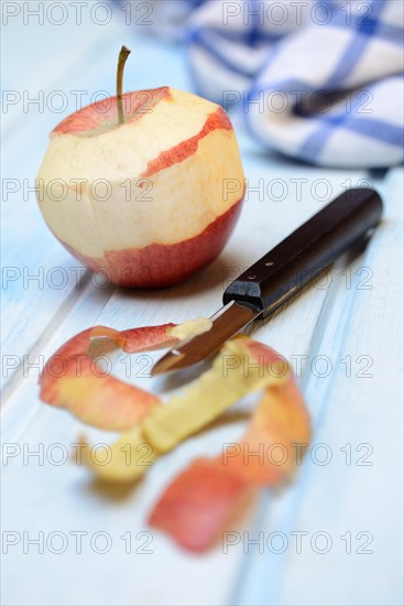 Peeled apple with peeling knife