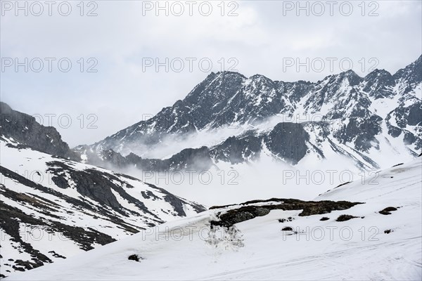 Mountains in winter with clouds and fog