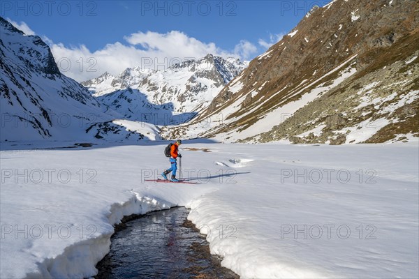 Ski tourers in the Oberbergtal valley on the Oberbergbach stream