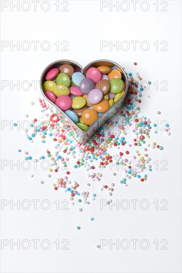 Chocolate lentils and love beads in heart-shaped cookie cutter