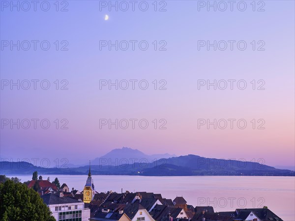 Illuminated Zytturm with old town on Lake Zug