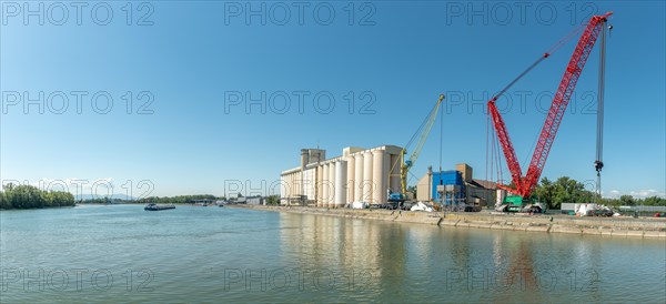 Rhine harbour of Colmar Neuf Brisach with big lifting crane on the banks of the Rhine. Alsace