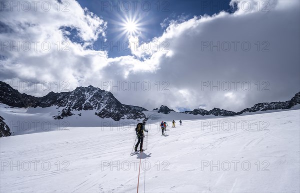 Group of ski tourers ascending on the rope