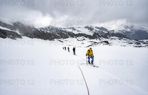 Ski tourers ascending the rope