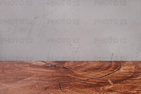 Abstract background with wooden tabletop and grey concrete wall
