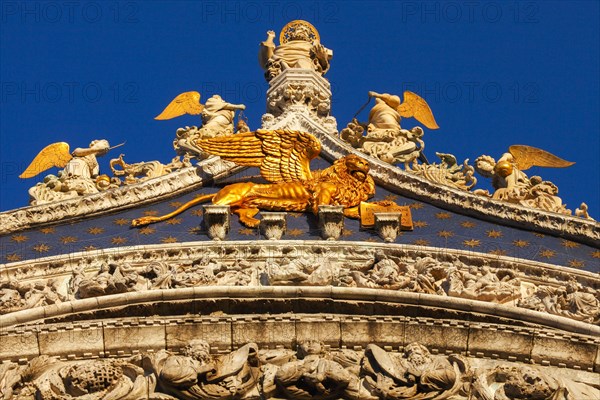 Gilded God the Father with angels and St. Marks lion on the gable of St. Marks Basilica