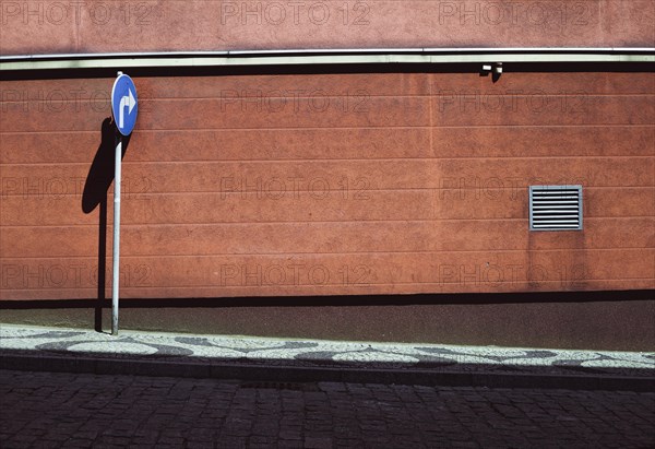 Empty street with blue road sign