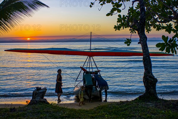 Flying Ultra light plane on a zodiac at sunset