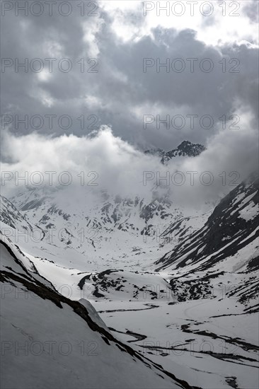 Mountains in winter with clouds and fog