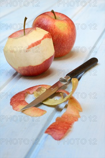 Peeled apple with peeling knife