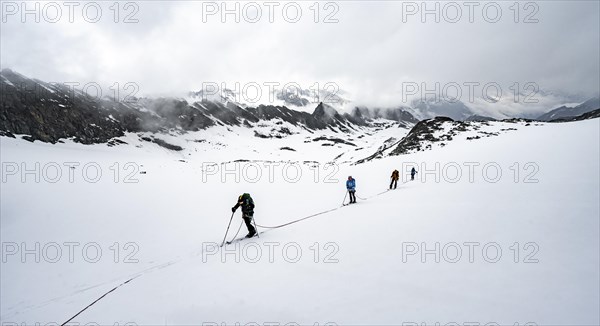 Ski tourers ascending the rope