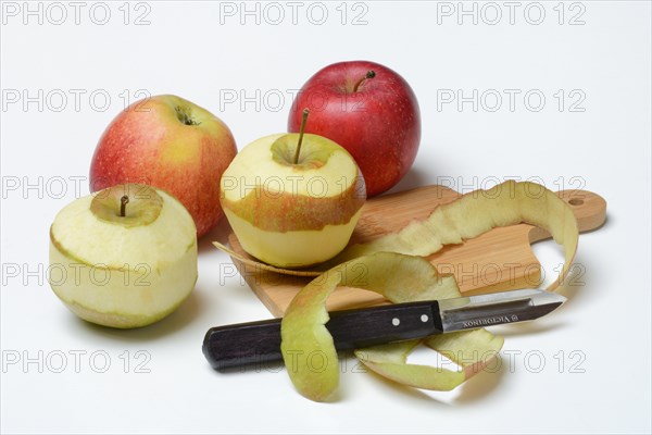 Peeled apples with peeling knife