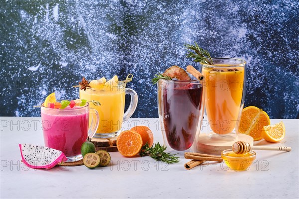Assortment of hot winter drinks with fruits and aromatic herbs