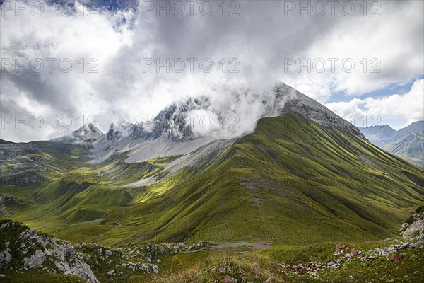 View from Gehrengrat over the fog-shrouded peaks of the Alps. Lech