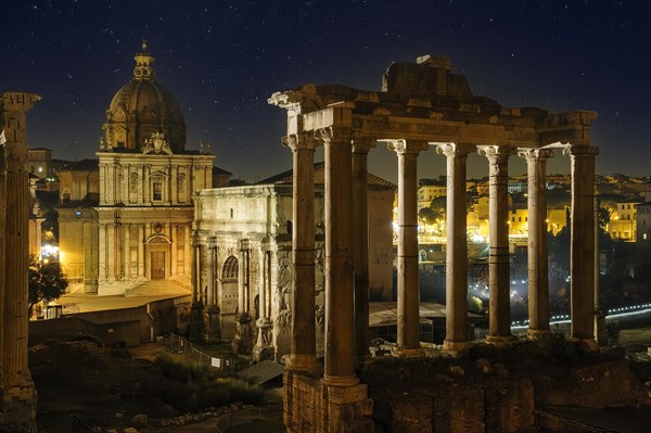 View of right Temple of Saturn of Roman religion centre Arch of Severus on Roman Forum left background Church of Santi Luca e Martina under starry sky night sky with stars