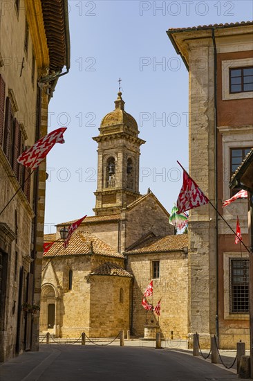 Red and white flags in the pedestrian zone of San Quirico dOrcia