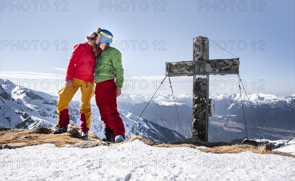 Ski tourers kiss at the summit