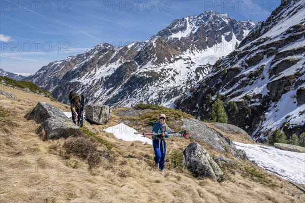 Ski tourers hiking in spring with little snow