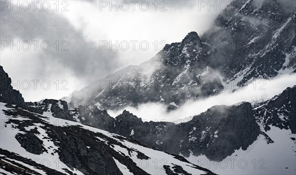 Mountains in winter with clouds and fog