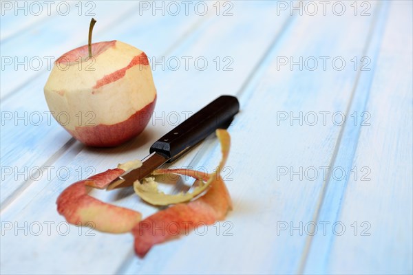 Peeled apple with peeling knife