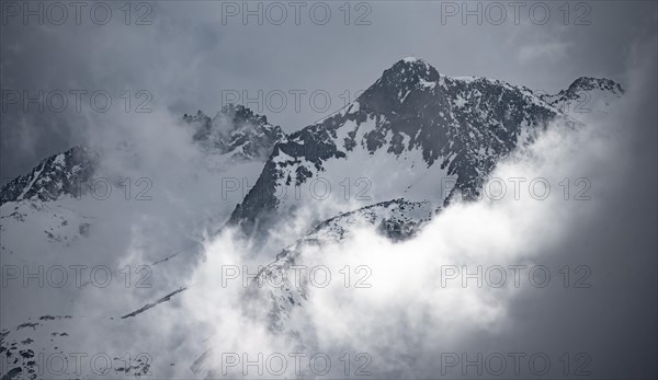 Mountains in winter with clouds and fog