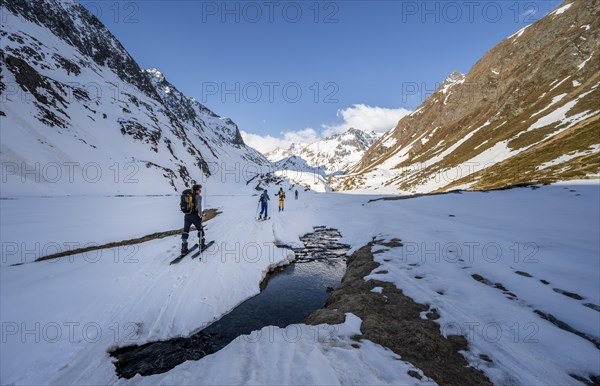 Ski tourers in the Oberbergtal valley on the Oberbergbach stream