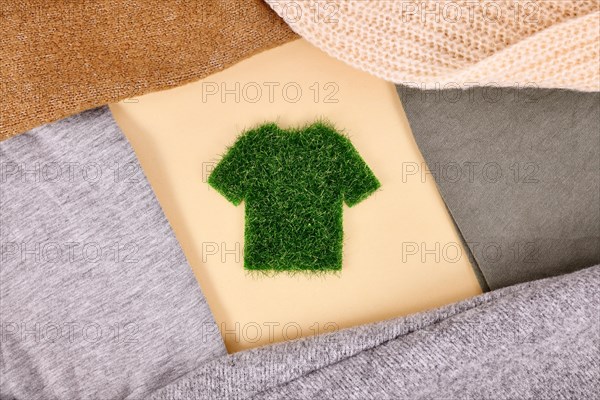 Environmental friendly produced clothing concept with shirt made out of grass surrounded by sweaters